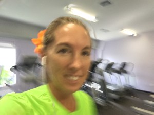 Treadmill selfie wearing my orange flower!